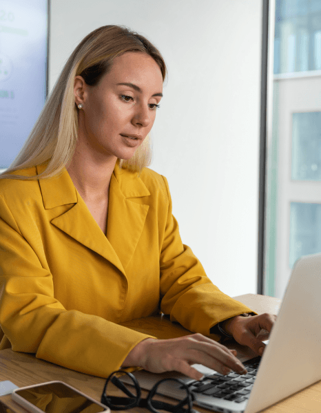 A typist builds a title page in Word as Manuscript Typing Services apply proper layout with clear headings and spacing.