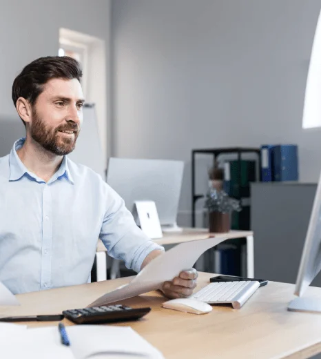 A marketer reviews a localized homepage while Quick Translation Services refines multilingual wording for global customers.