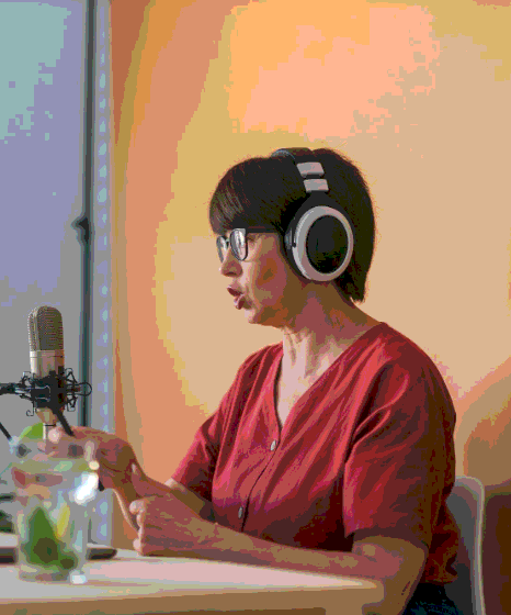 A client listens to regional accent demos for Vietnamese Voice Over Services on headphones.