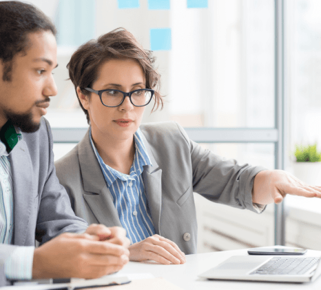 A small team reviews translated pages around a table, showing reliable eBook Translation Services done by human linguists.