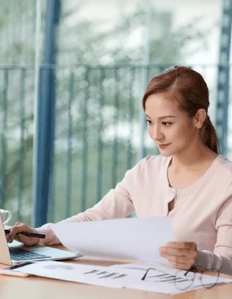 A linguist reviews a same-day contract draft on dual monitors as Quick Translation Services delivers accurate results.