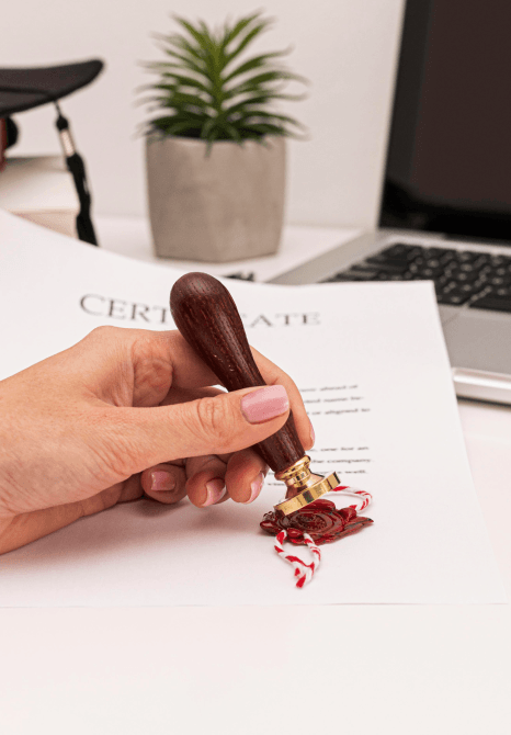  A project manager stamps a certified packet after Book Translation Services, preparing official documents for submission.
