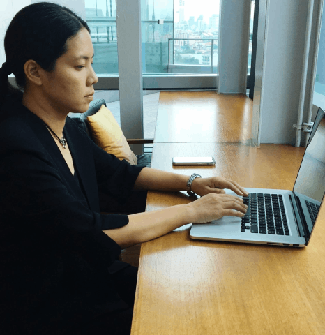 A specialist confirms encrypted transfer for Indonesian translation services, checking file integrity before secure delivery.