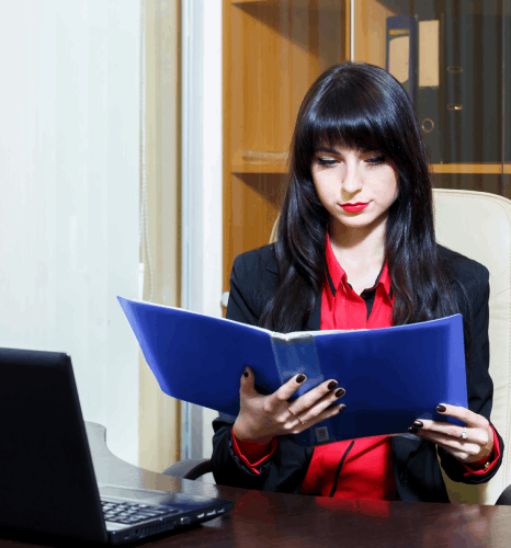 A project lead reviews a formatted report draft, using Kazakh translation services for professional documents and layout.