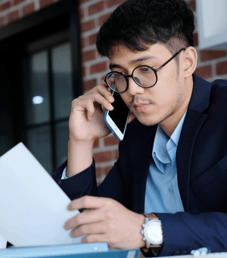 A manager reviews bilingual presentation slides, using Thai translation services to keep corporate messaging consistent.