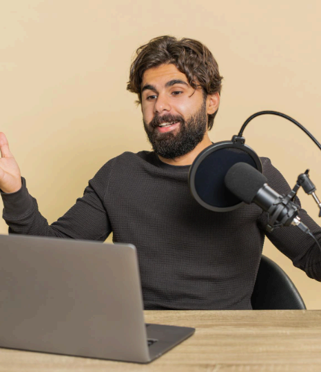 A voice talent records regional Urdu dialect lines in a studio booth during Urdu Voice Over Services for community messaging.