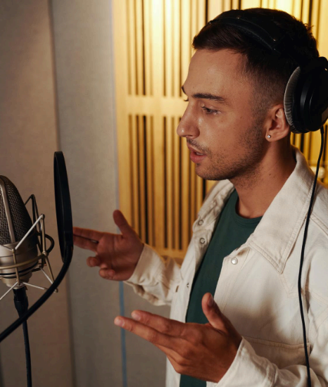 A voice talent records a Sardinian read in studio, using Italian Voice Over Services to build regional audience connection.