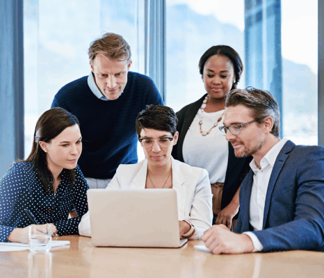 A project team reviews a six-language corporate policy suite as insurance translation services support business rollout.