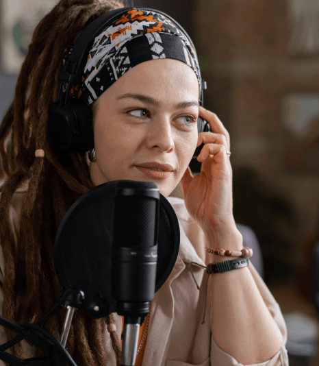 An experienced voice artist records in a booth, showing top reasons clients choose our Telephone Voiceover Services.