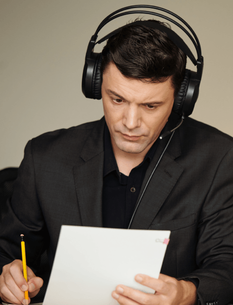 An editor fine-tunes timing and formatting as corporate video captioning services keep each line synced to speech.
