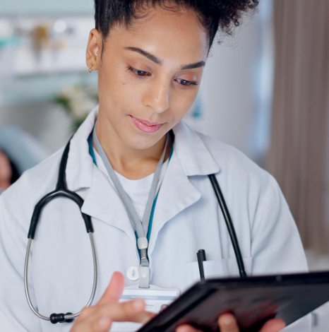 A compliance officer reviews bilingual discharge papers for Title VI medical records translation in New York at a hospital.