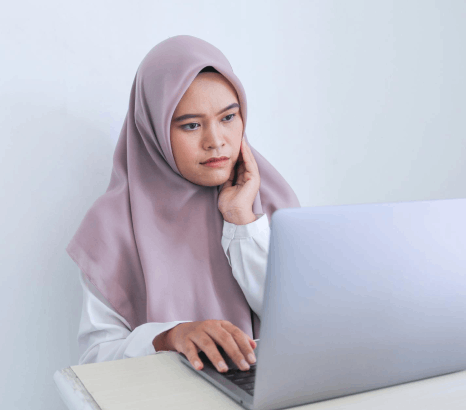 A UI designer tests Malay buttons and date formats, using Malay translation services for regional localization accuracy.