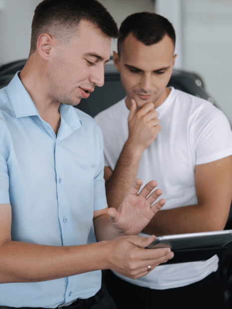 A team checks in-car UI strings while automotive translation services support engineering software localization.