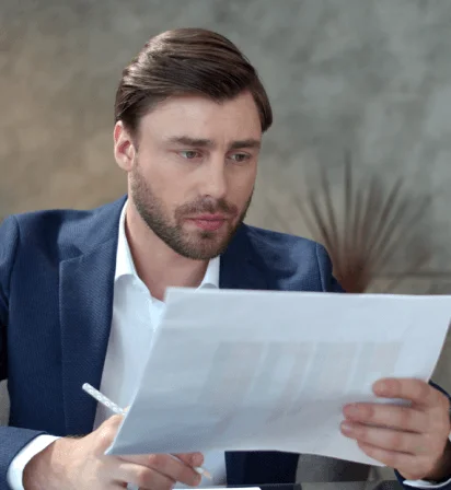 A project manager prioritizes urgent files for Quick Translation Services, reviewing a contract and a certificate on screen.