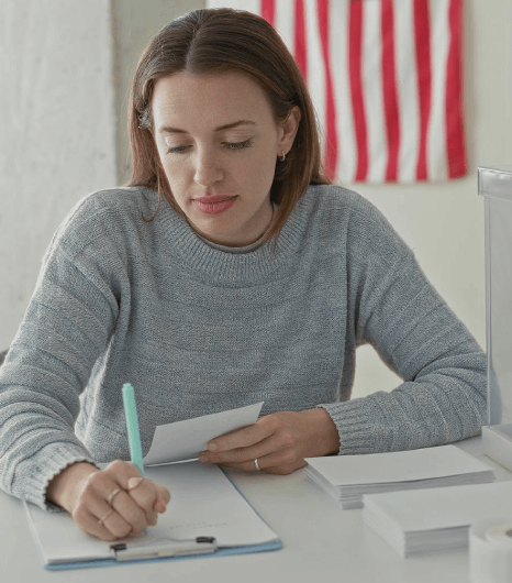 A certified translator checks names and dates on USCIS forms using Slovak translation services for immigration filing.