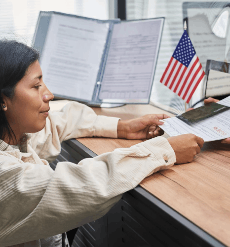 A client reviews a USCIS document set with a translator, using Tagalog Translation Services for immigration paperwork.