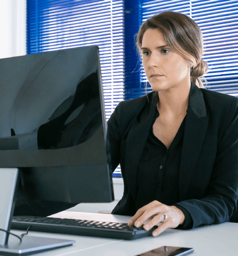 A translator reviews varied documents on dual monitors as immediate translation services prepare accurate files in laptop.