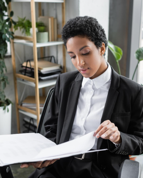 A translator checks a bilingual glossary for ATA certified translation services in New York to keep trusted terminology.