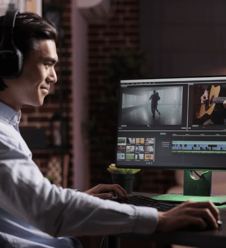 Male videographer editing movie footage on color grading software, highlighting expert video dubbing services for audiences.