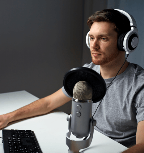 Audio director coaches a performer at the mic, highlighting why choose us for video game voice over services quality.