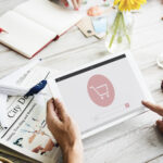 A person holding a tablet device with a screen displaying e-commerce localization services.