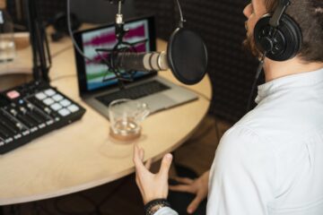 Illustration of a professional voice over artist recording in a studio for business hiring best practices.