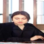 A professional translator working on a birth certificate to translate