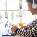 A Closed Captioning expert person working on laptop for Closed Captioning company