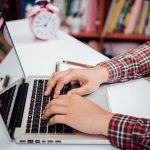 Close up young man working and smart phone and laptop