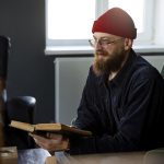 Side view man sitting on chair