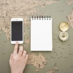 Stories and books traveling across a world map representing how translation helps great stories journey farther globally