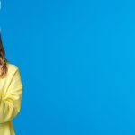 Thoughtful cute caucasian girl in rabbit ears thinking looking up pondering and dreamy holding easte