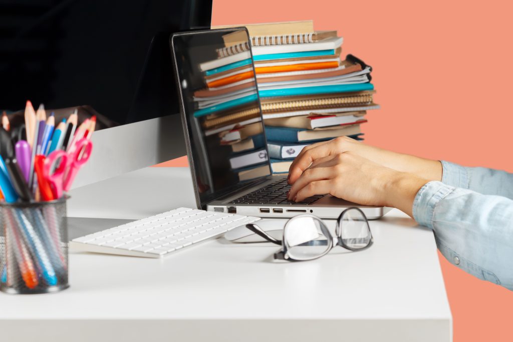 Person organizing and sorting documents and files on desk before sending them for professional typing services
