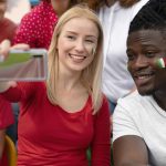 People taking a selfie at a football game