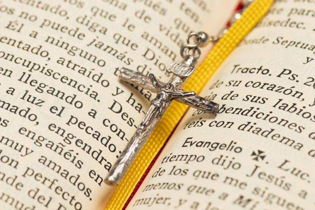 Close-up necklace cross and holy book