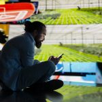 Stressed individual obsessively overuses his mobile phone social platforms