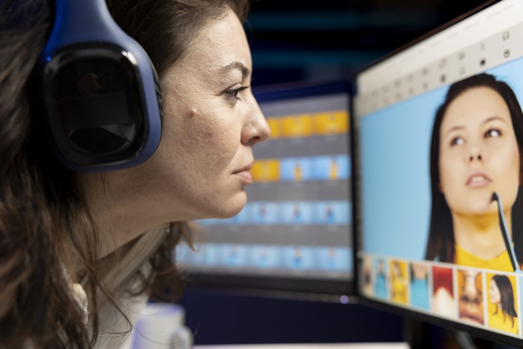 Content specialist selects best pictures for social media while listening music