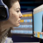 Content specialist selects best pictures for social media while listening music