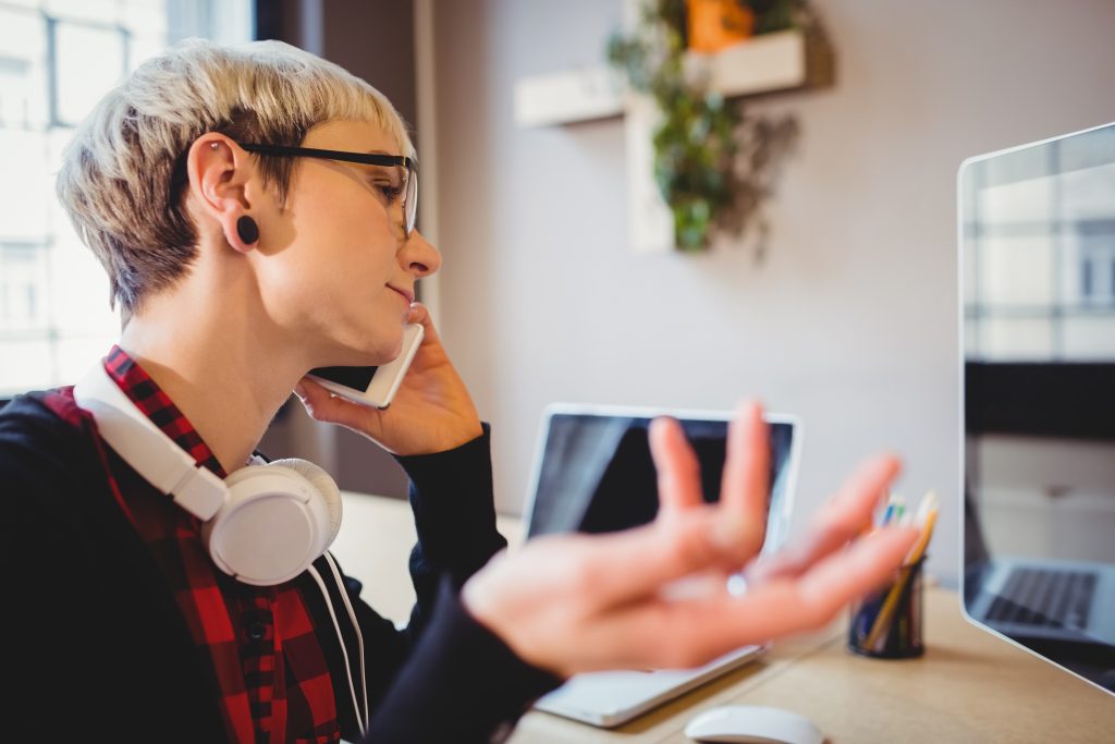 Person using assistive communication device with translation symbols helping world listen closer to fading voice