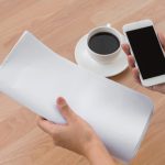 A phone showing a delivered translation email on a Monday morning next to a coffee cup and a printed three-page document - Real Story: A Saturday-Night featured image