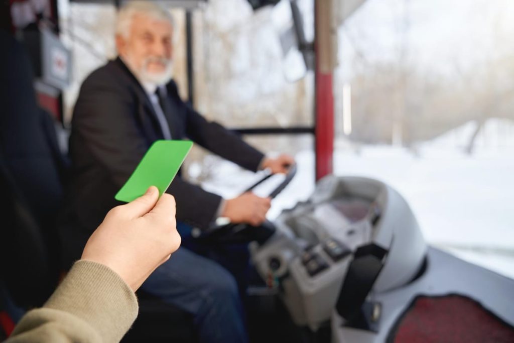A European driver's license card on a desk beside a signed certificate of translation, with a commuter train platform softly blurred in the background - Real Story: Translating a featured image