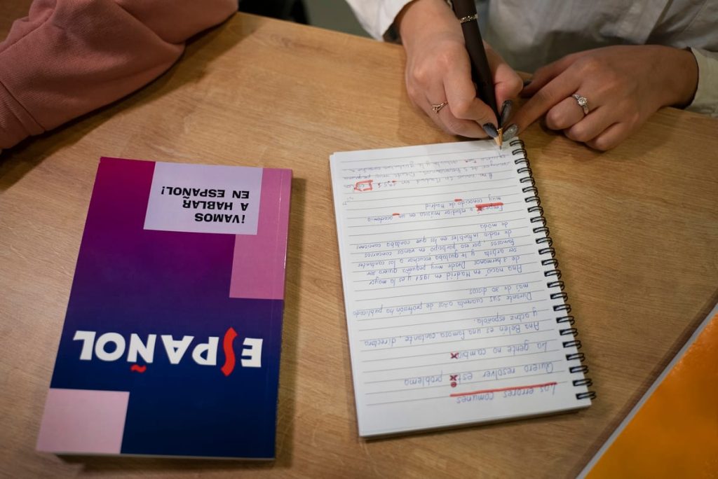 A school transcript page in Spanish resting beside its typed English translation and a signed certificate of translation - Real Story: A Child's featured image
