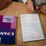 A school transcript page in Spanish resting beside its typed English translation and a signed certificate of translation - Real Story: A Child's featured image
