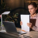 A vital records form on a desk under a lamp in the evening, beside a printed French translation and a signed certificate - Real Story: A Death featured image