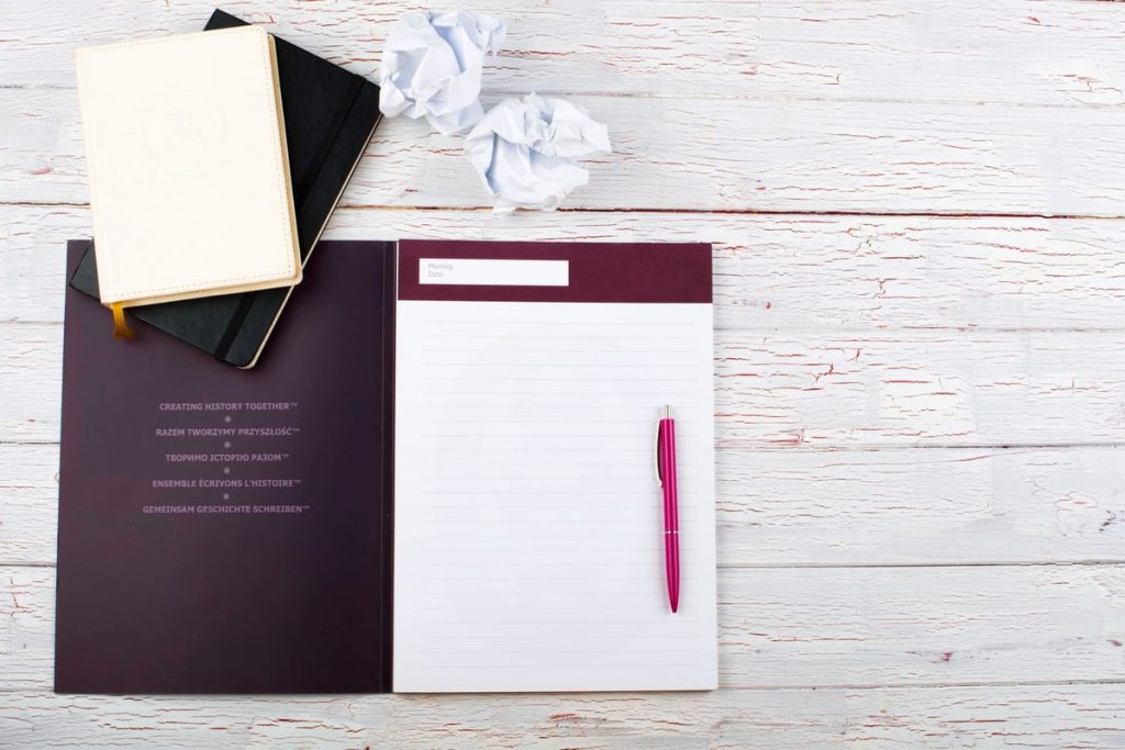 A European booklet-style birth certificate open on a desk beside a typed English translation and a signed certificate page - Real Story: A Hungarian featured image
