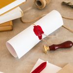 A long English contract translation on a desk beside printed pages, each stamped with a round company seal in the lower corner - Real Story: Two More featured image