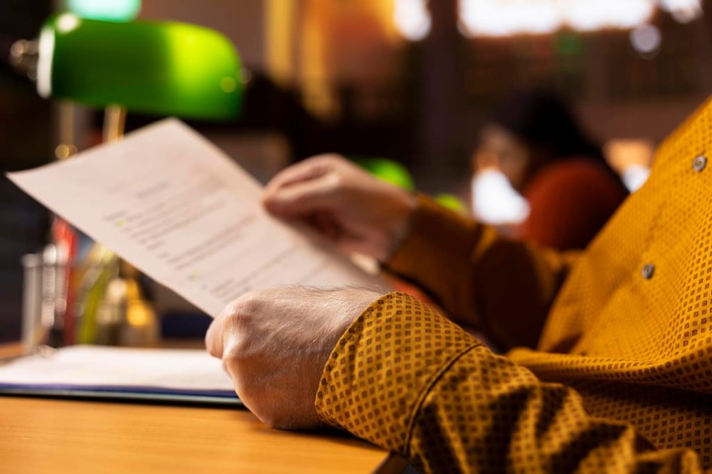 Two Spanish-language personal documents on a desk, one photographed sharply and one blurred, beside a typed English translation - Real Story: Two Spanish featured image