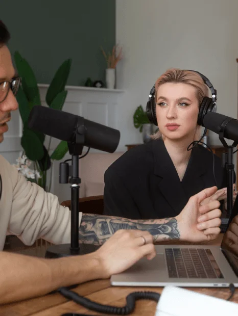 A voice actor records a dubbed movie scene while a linguist guides phrasing, using Media Localization Services.