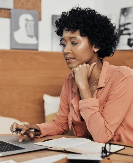 An ecommerce manager reviews a localized storefront on a laptop, using Media Localization Services to tailor checkout text.